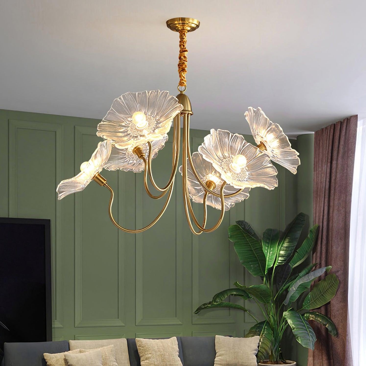 Clear flower chandelier near plant and green wall