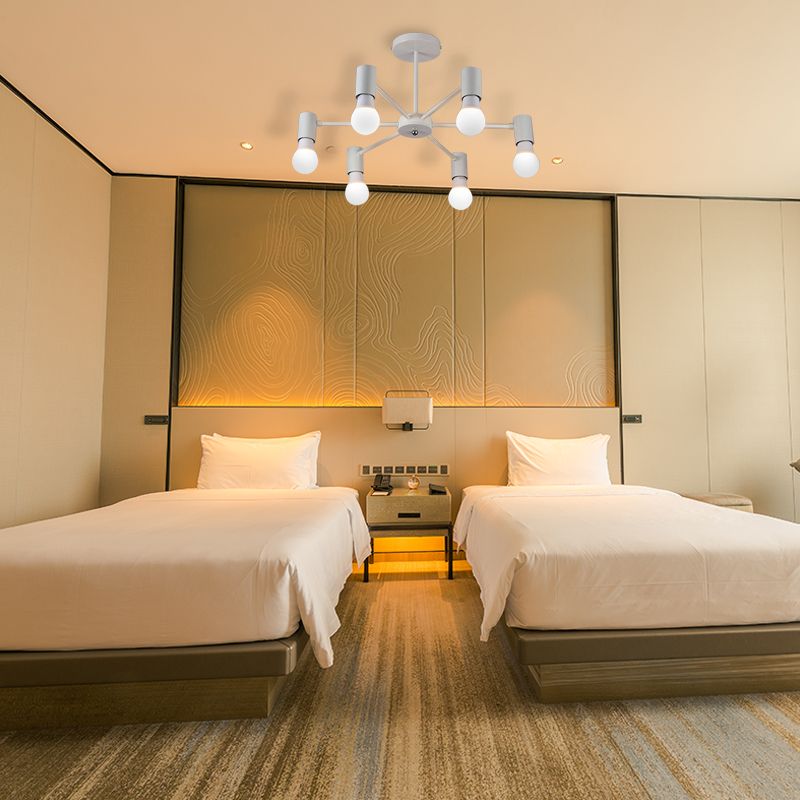 White six-light ceiling fixture above twin beds and a patterned wall with warm accent lighting