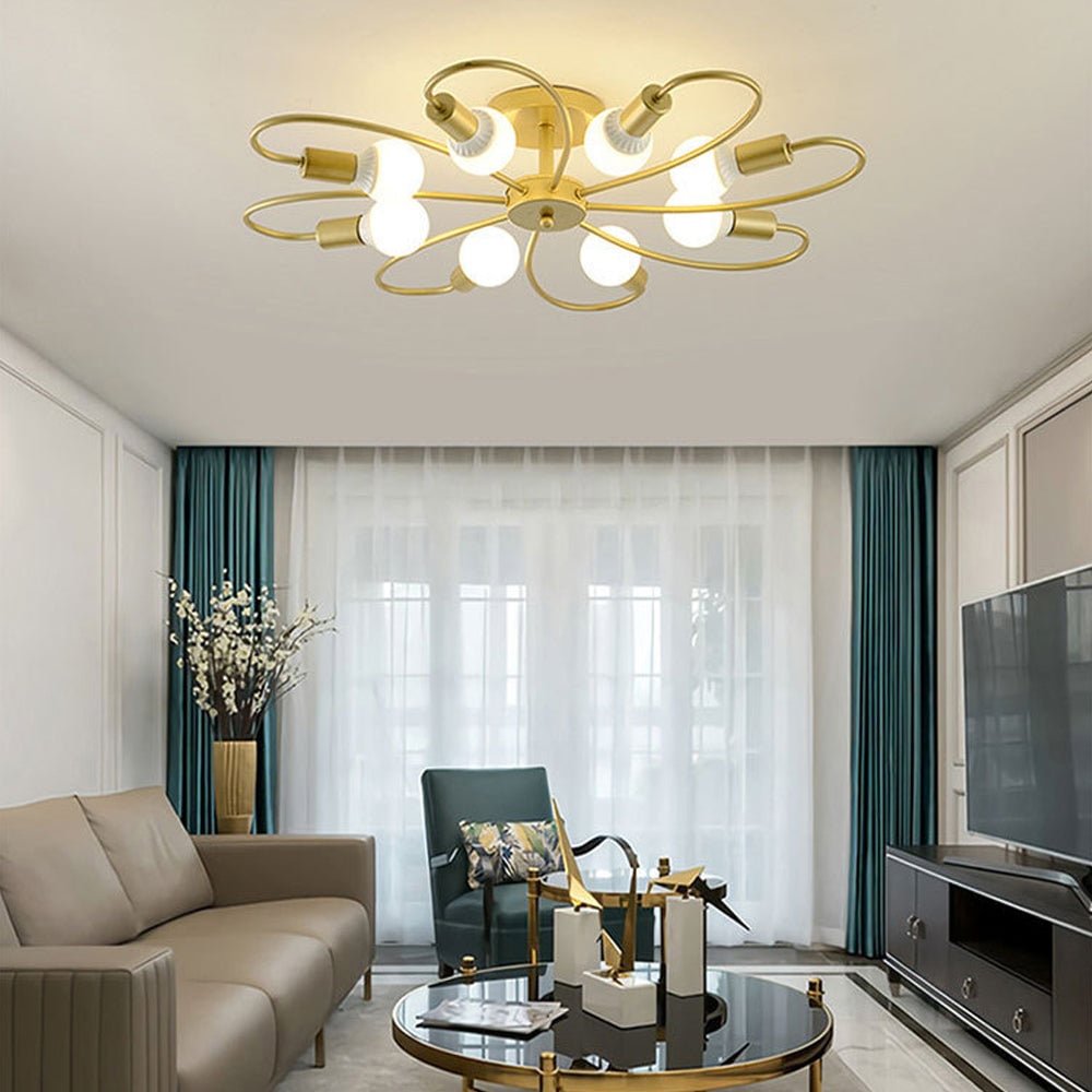Valentina Gold eight-loop light above a taupe sofa, teal chair and curtains, round coffee table and black TV cabinet.