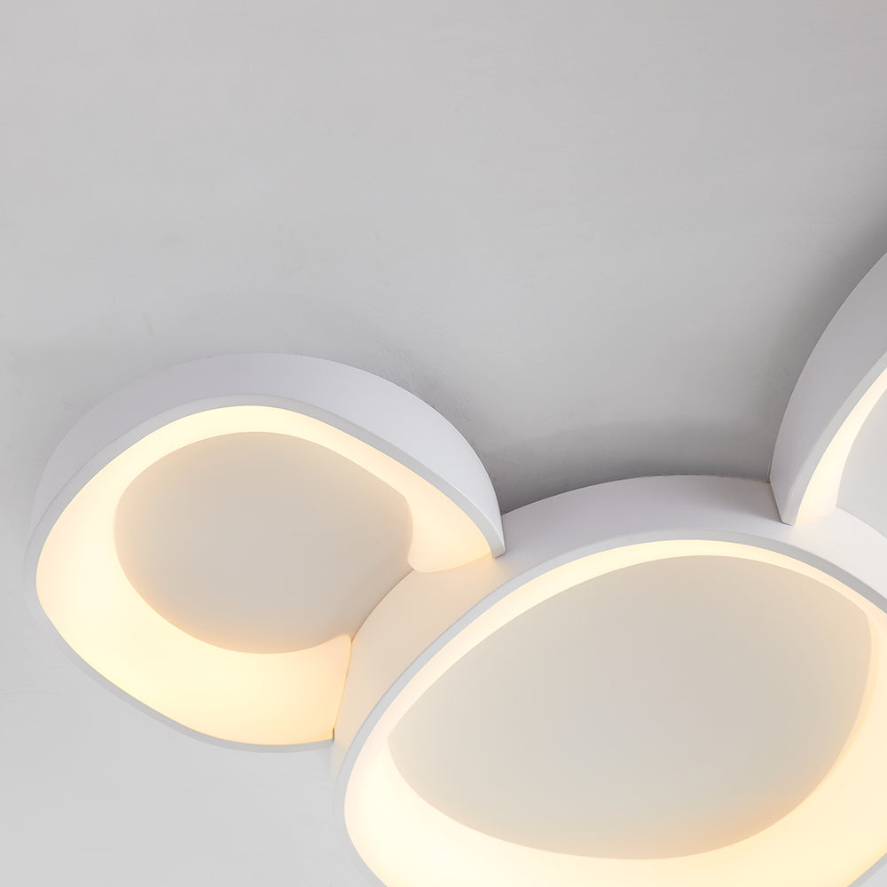 Ceiling-side detail of adjoining white Arisha bowls, pale concave centres and warm-looking channels around the rims.