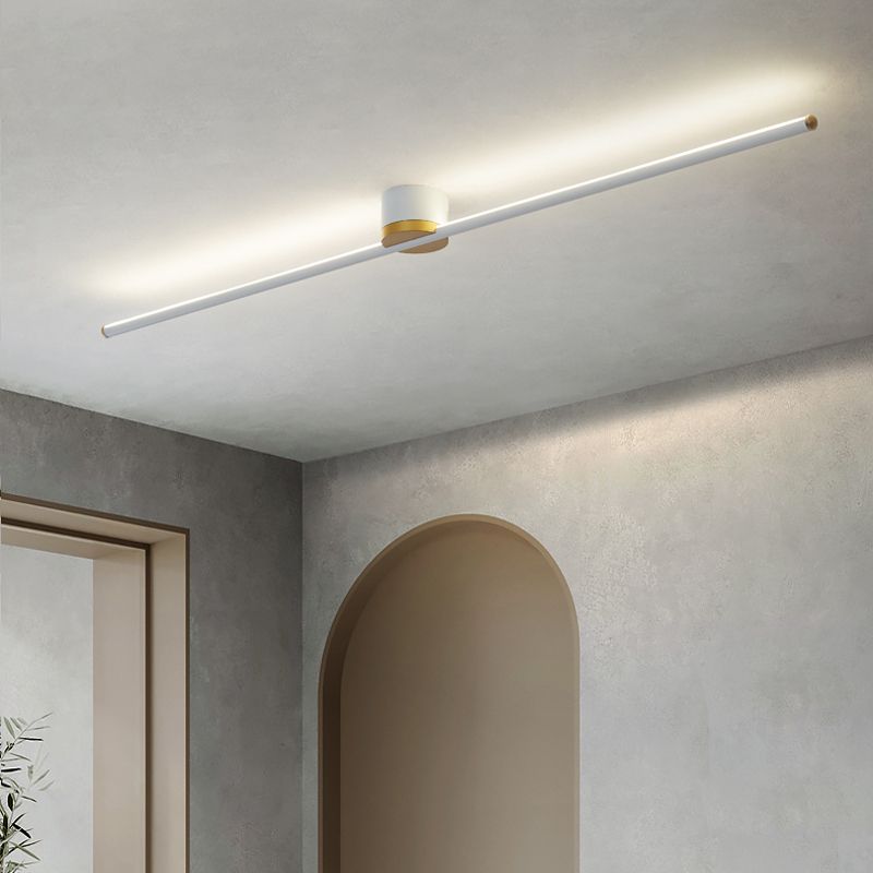 White Edge bar with a bright ceiling halo above a wood-tone arched alcove, gray textured walls and a plant corner.