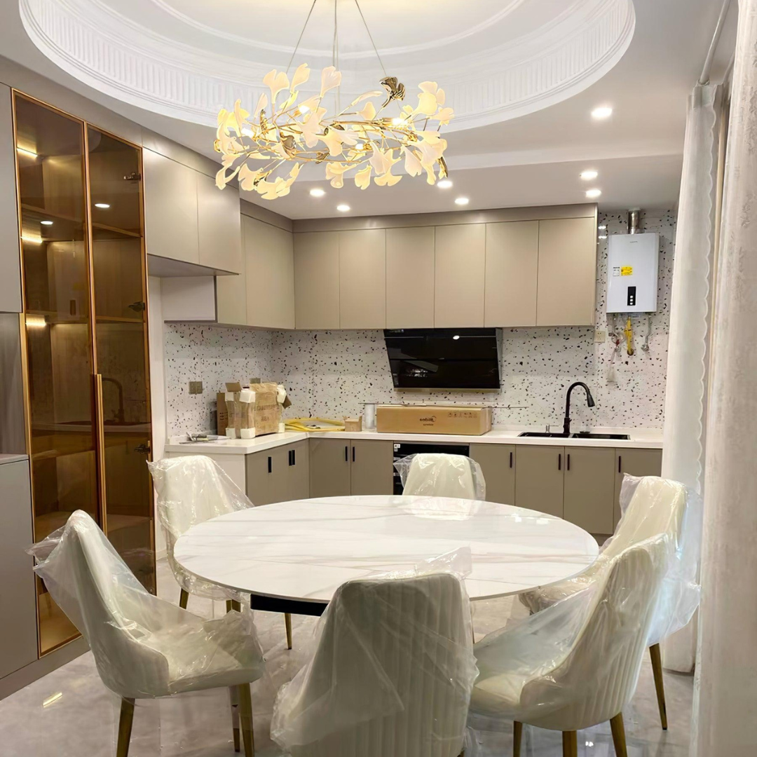 White-leaf chandelier above a round kitchen table