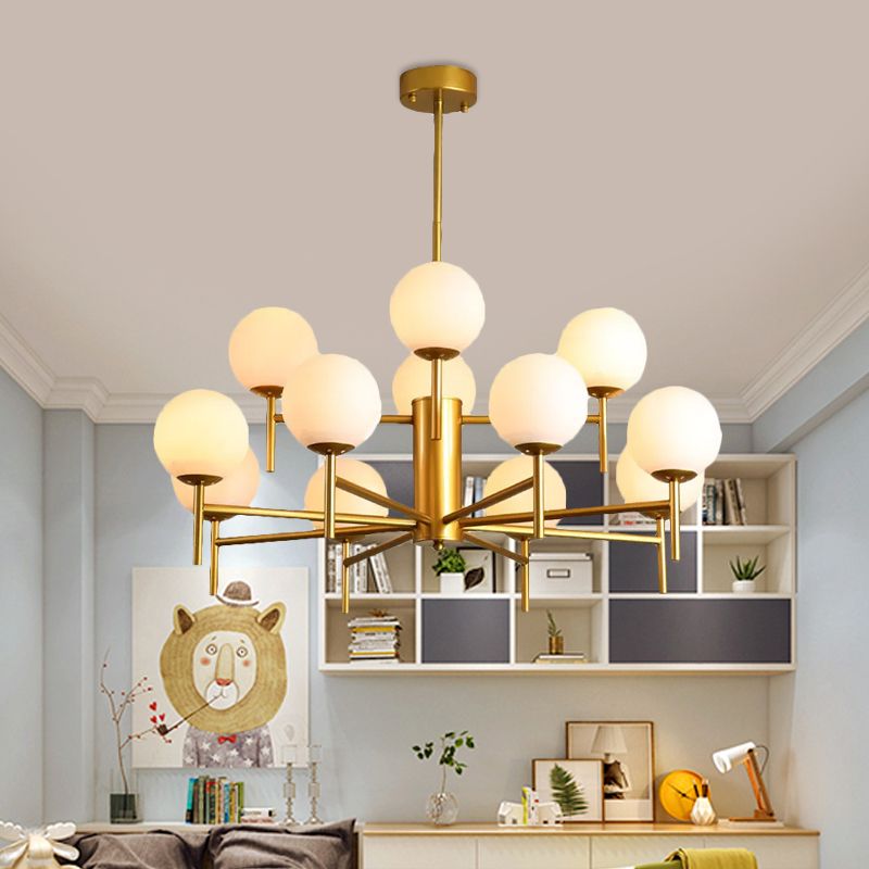 Gold twelve-light Valentina chandelier with white globes in a dining room