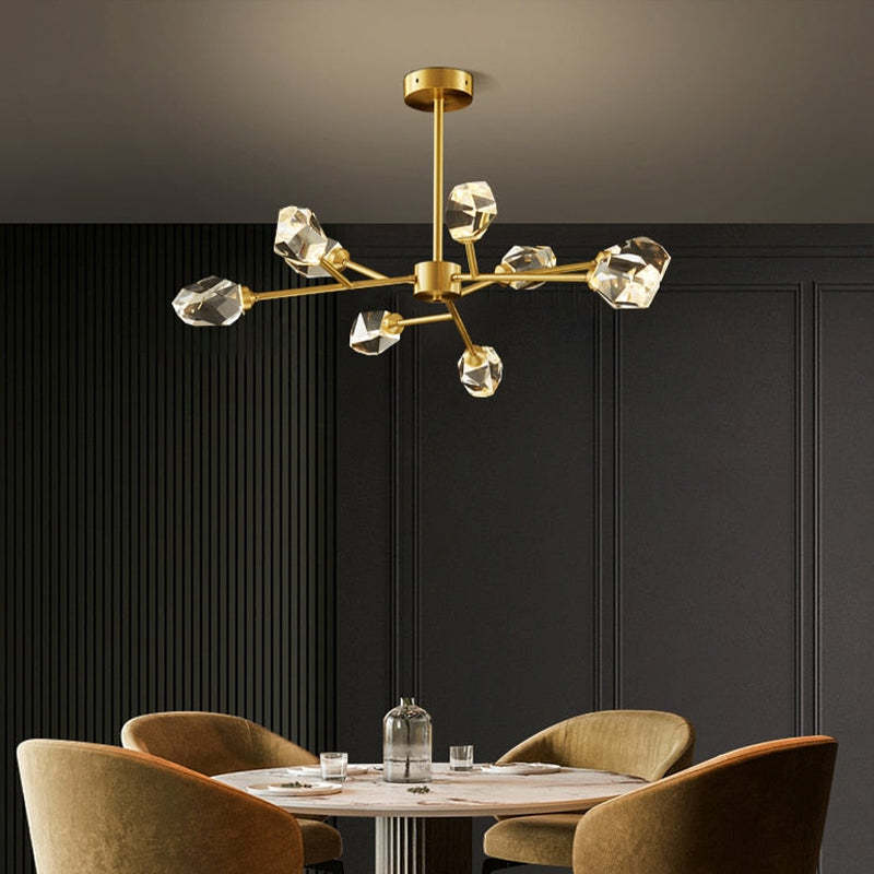Kristy 9-light option above a round dining table and ochre chairs against dark panelling and a fluted wall.