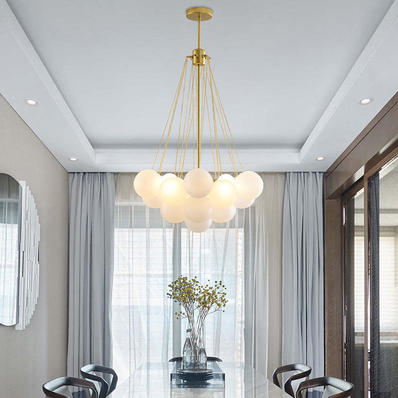Gold 19-globe pendant above a round table