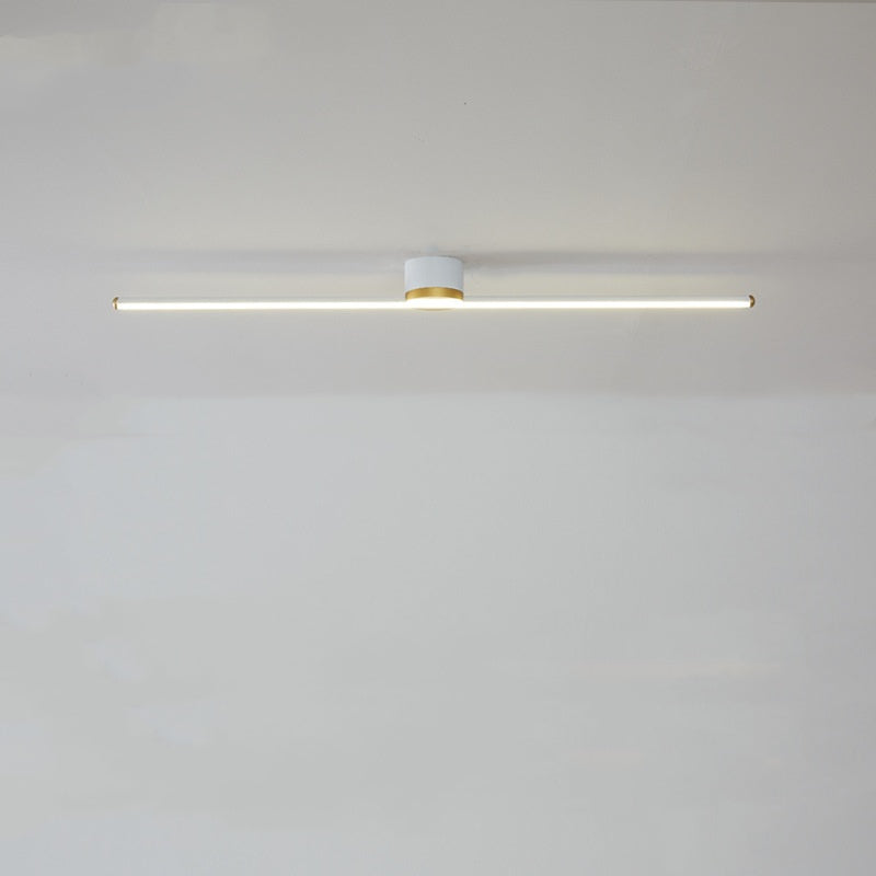 White Edge horizontal bar below a white cylindrical mount, with a lit lower strip and gold-tone rim and end details.