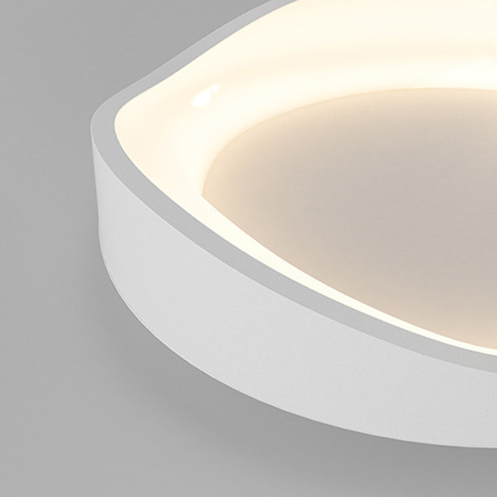 Close-up of a single Arisha bowl’s curved white outer edge, pale centre and warm-looking luminous inner rim.