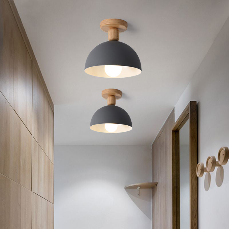 Gray Ozawa Dome lights with wooden canopies and visible bulbs, hallway wood cabinetry, mirrors and circular wall hooks
