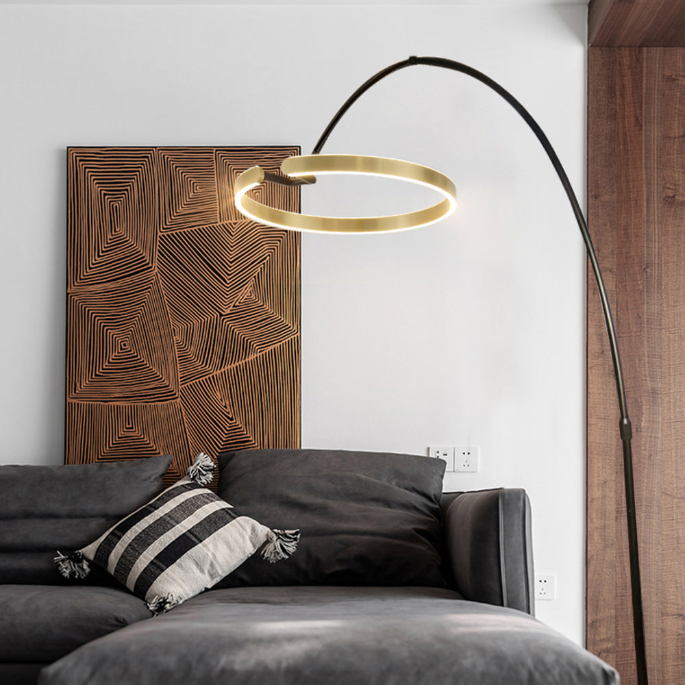Gold-tone Edge light ring above a black sofa