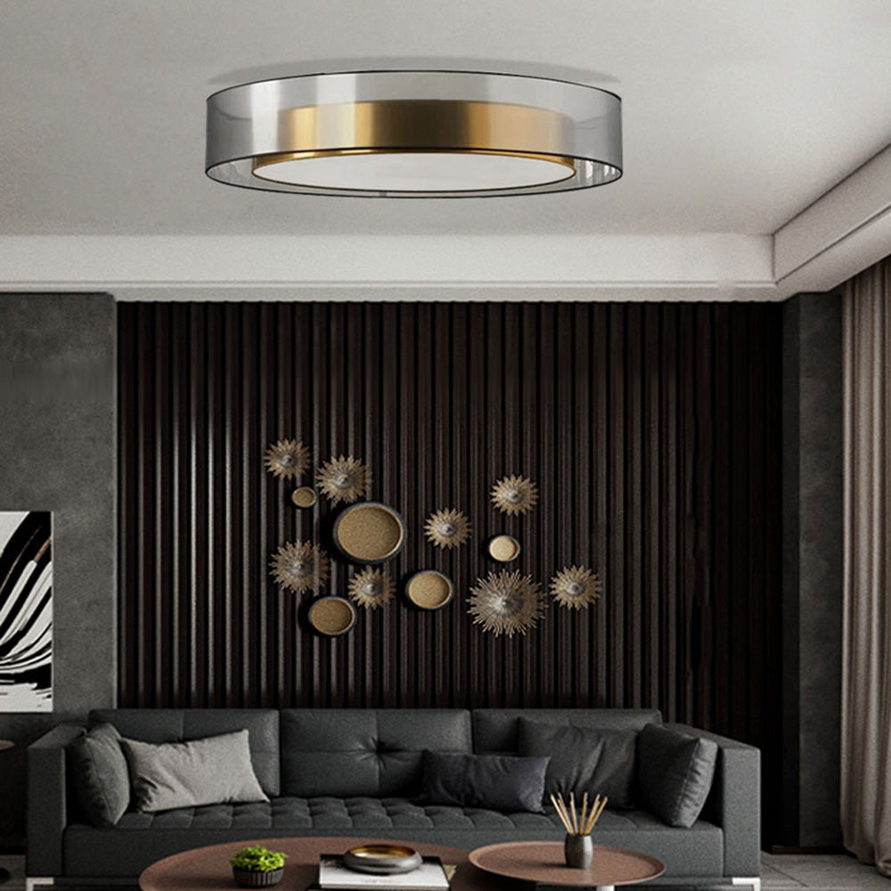 Quinn above a dark grey sofa and black slatted wall with gold-tone circular ornaments, beside separate round coffee tables.