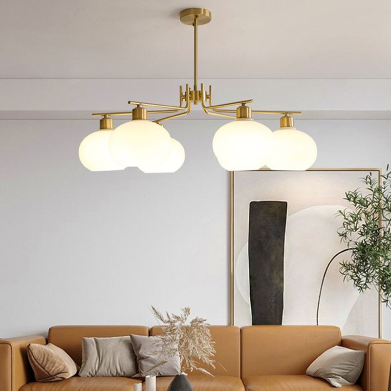 Valentina brass-finish chandelier above a sofa and coffee table