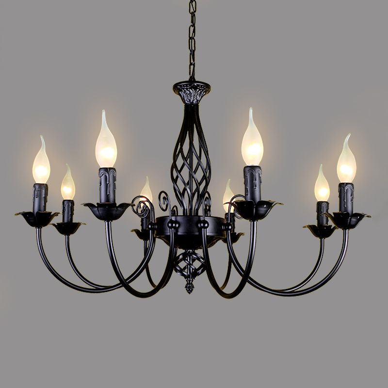 Black Silva eight-light chandelier isolated on grey, with lit candle-style holders, curved arms and open twisted central column
