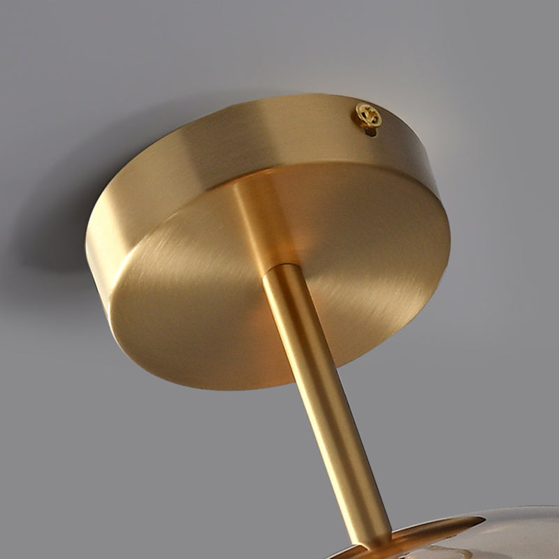 Close-up of gold-tone Sanna round canopy with side screw, rigid metal stem and the top shade cap.