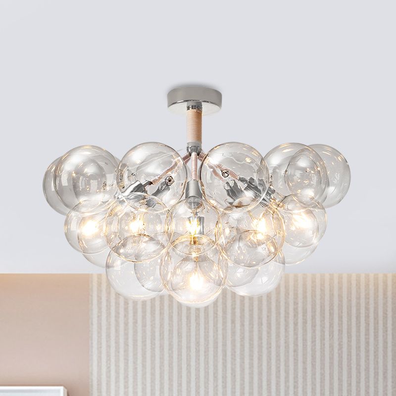 Chrome six-light clear globe cluster above a peach wall and striped curtain