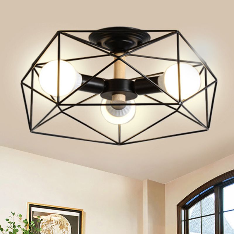 Black three-light Cooley lantern beside an arched dark-framed window, pale wall, leafy plant and framed artwork.