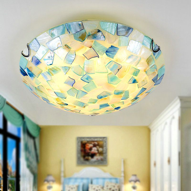 Blue-toned Morandi shell-mosaic ceiling light shown illuminated indoors.