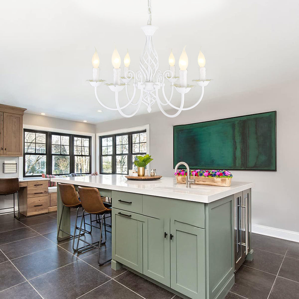 White Silva six-light chandelier above kitchen island with sink and stools, wooden cabinets and green wall artwork