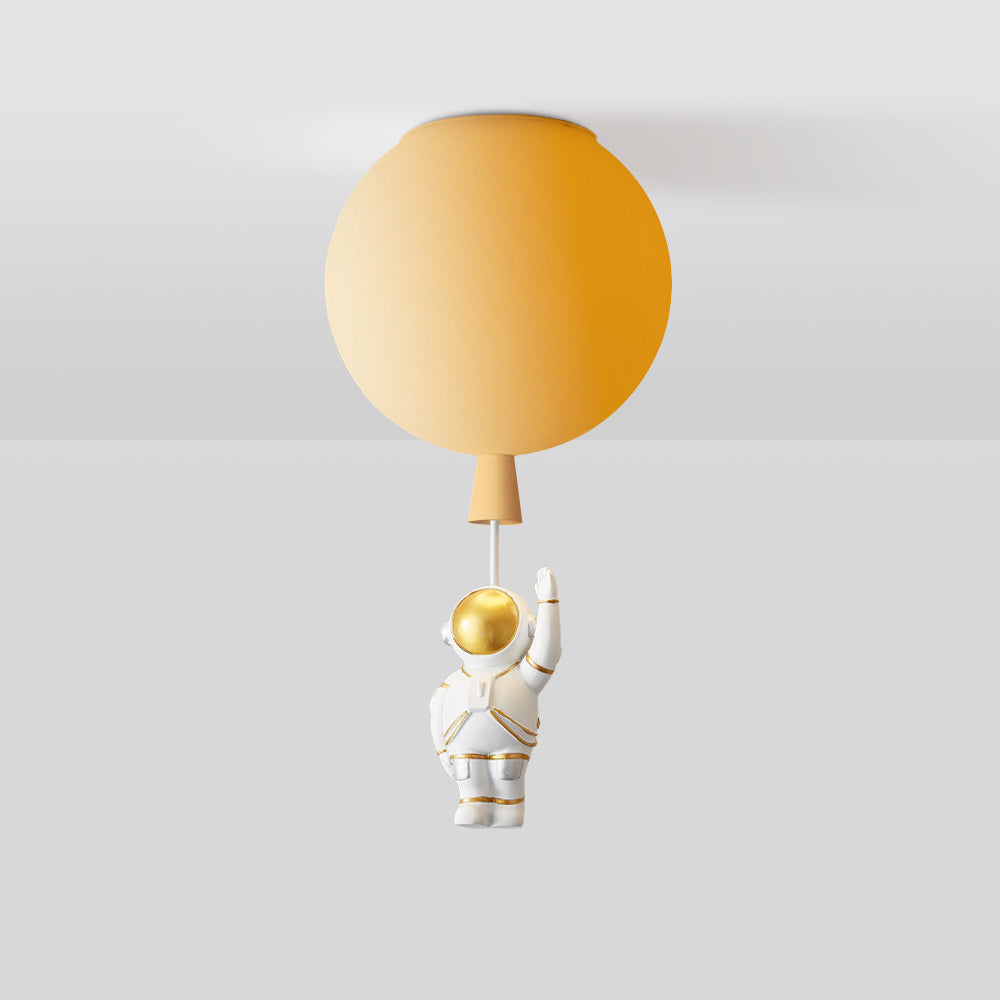Cropped orange balloon globe with a tapered lower detail and a short pale link; the astronaut is outside the image.