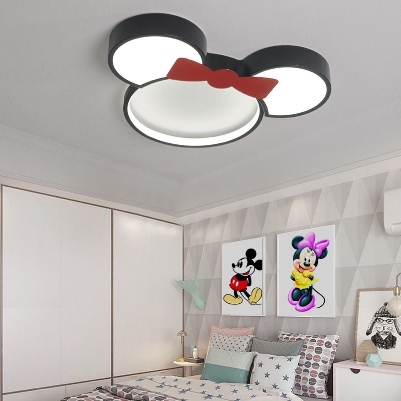Freja red-bow ceiling light above a decorated bed.