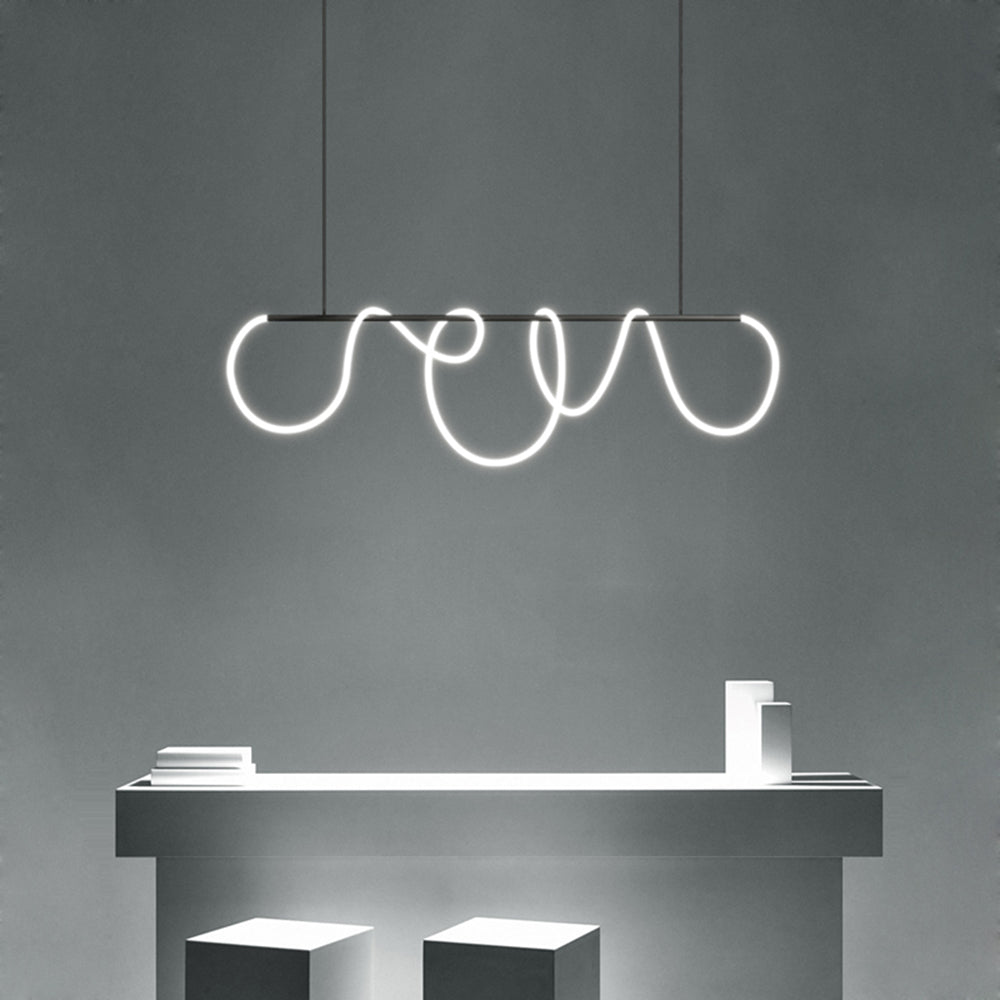 Black Louise linear light with white loops above a gray island with books and white objects, beside two white stools.