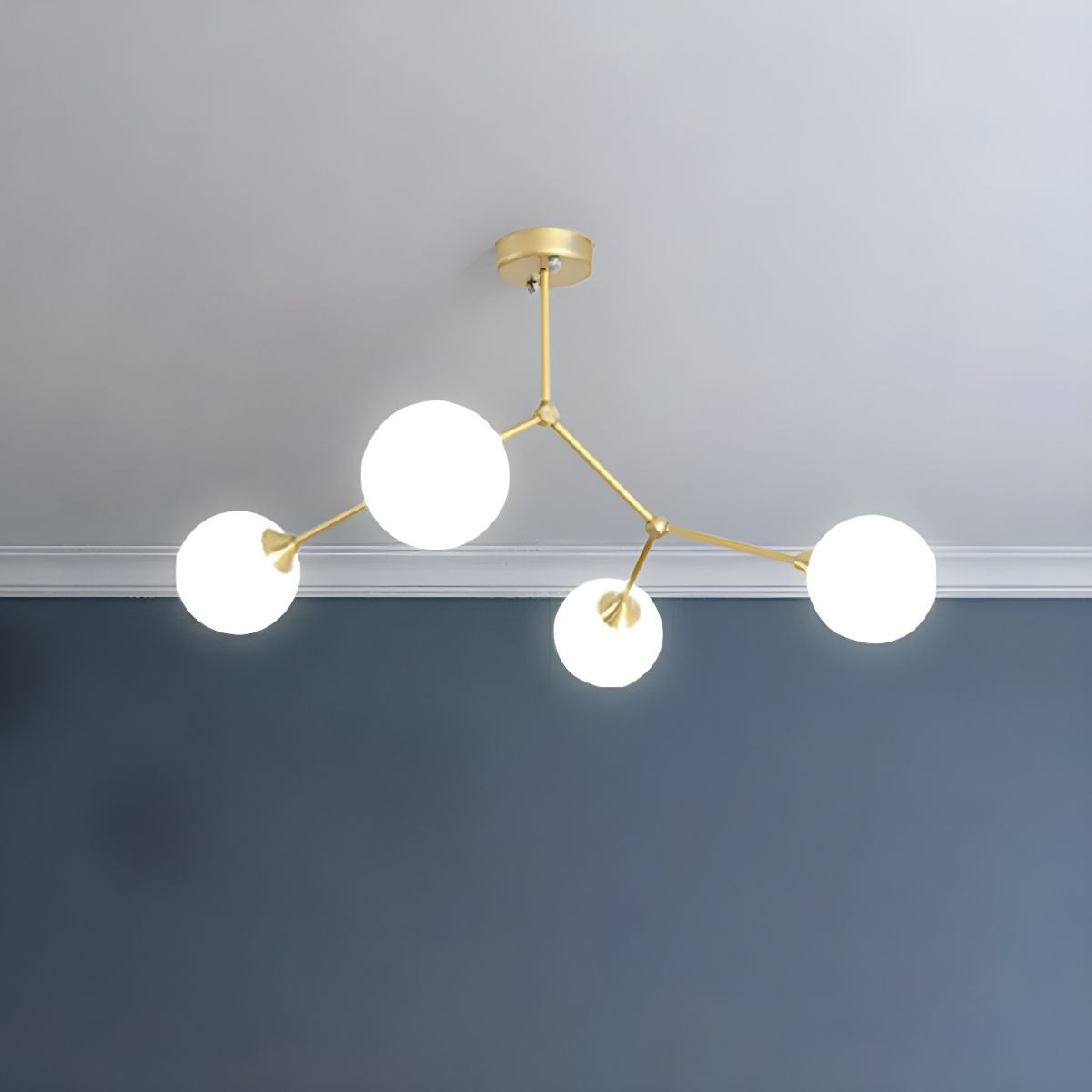Gold-tone Valentina chandelier with four white glass globes