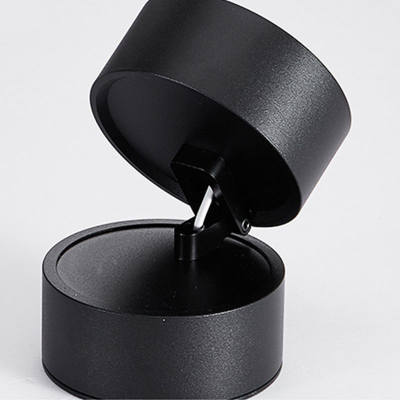 Black Novak close-up showing a round base, hinge, small bolt, visible cable and tilted cylindrical head.