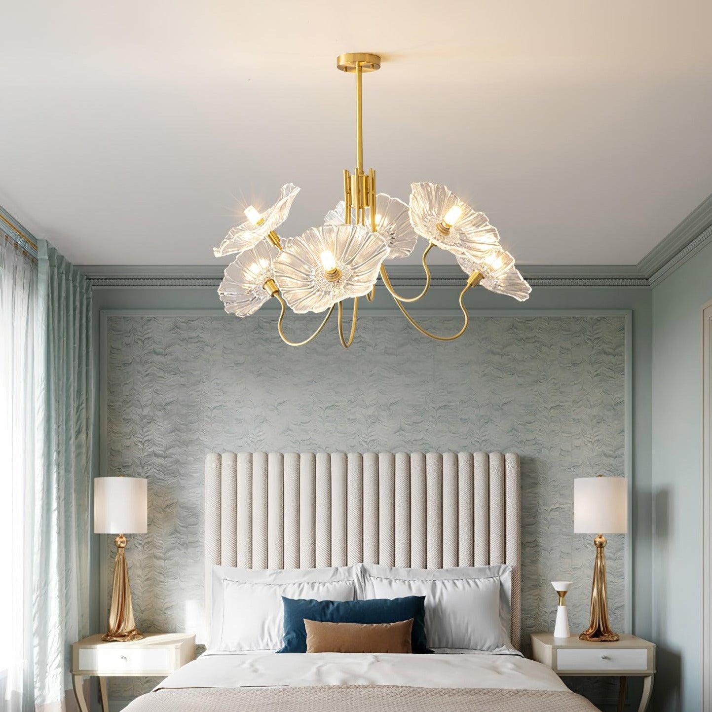 Clear chandelier above bed