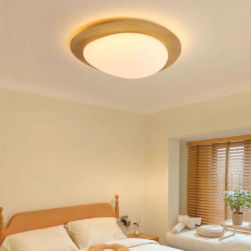 Natural wood-effect Quinn ceiling light above a bed