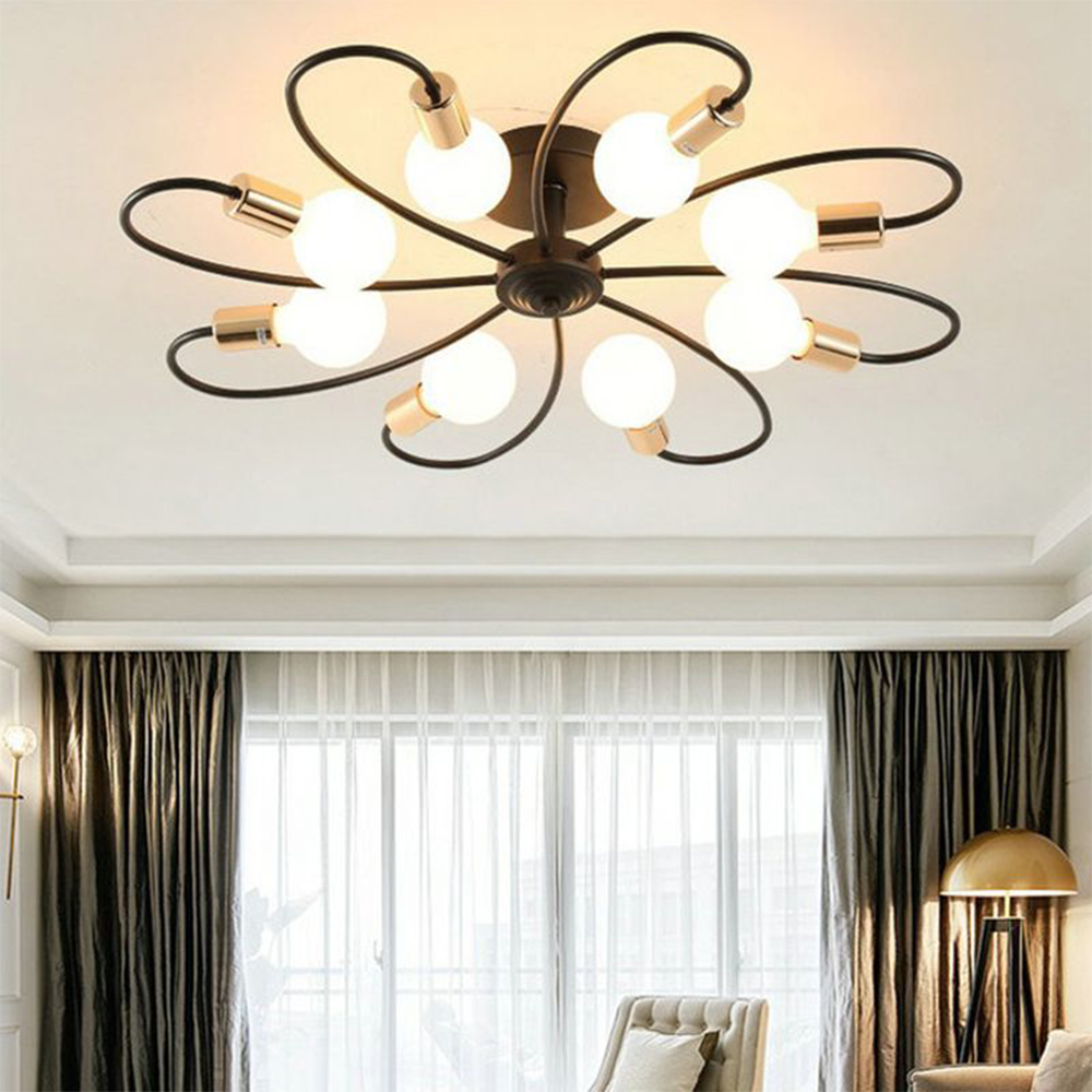 Valentina Black eight-loop light above a pale chair and curtained window, with a separate gold dome floor lamp.