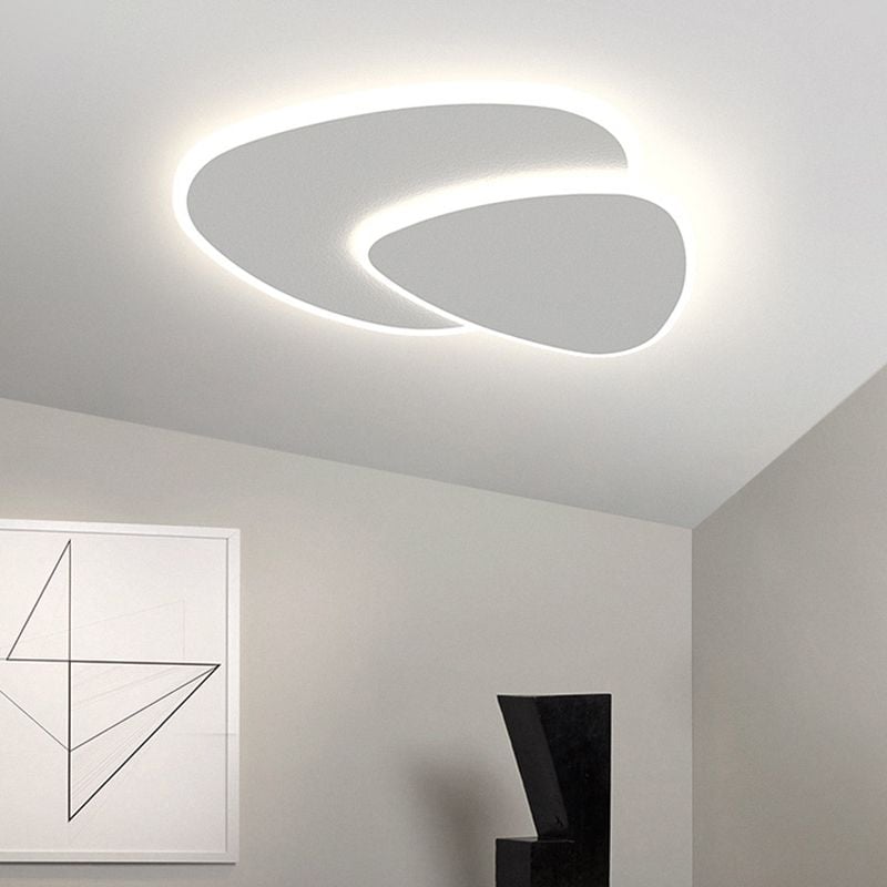 Quinn white ceiling light in a grey room with a black sculptural chair and framed geometric line art.
