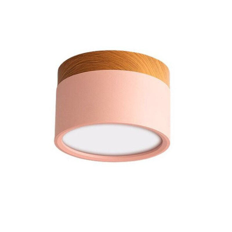 Unlabeled pink Morandi cylinder on white backdrop with wood-look upper band and pale round diffuser.
