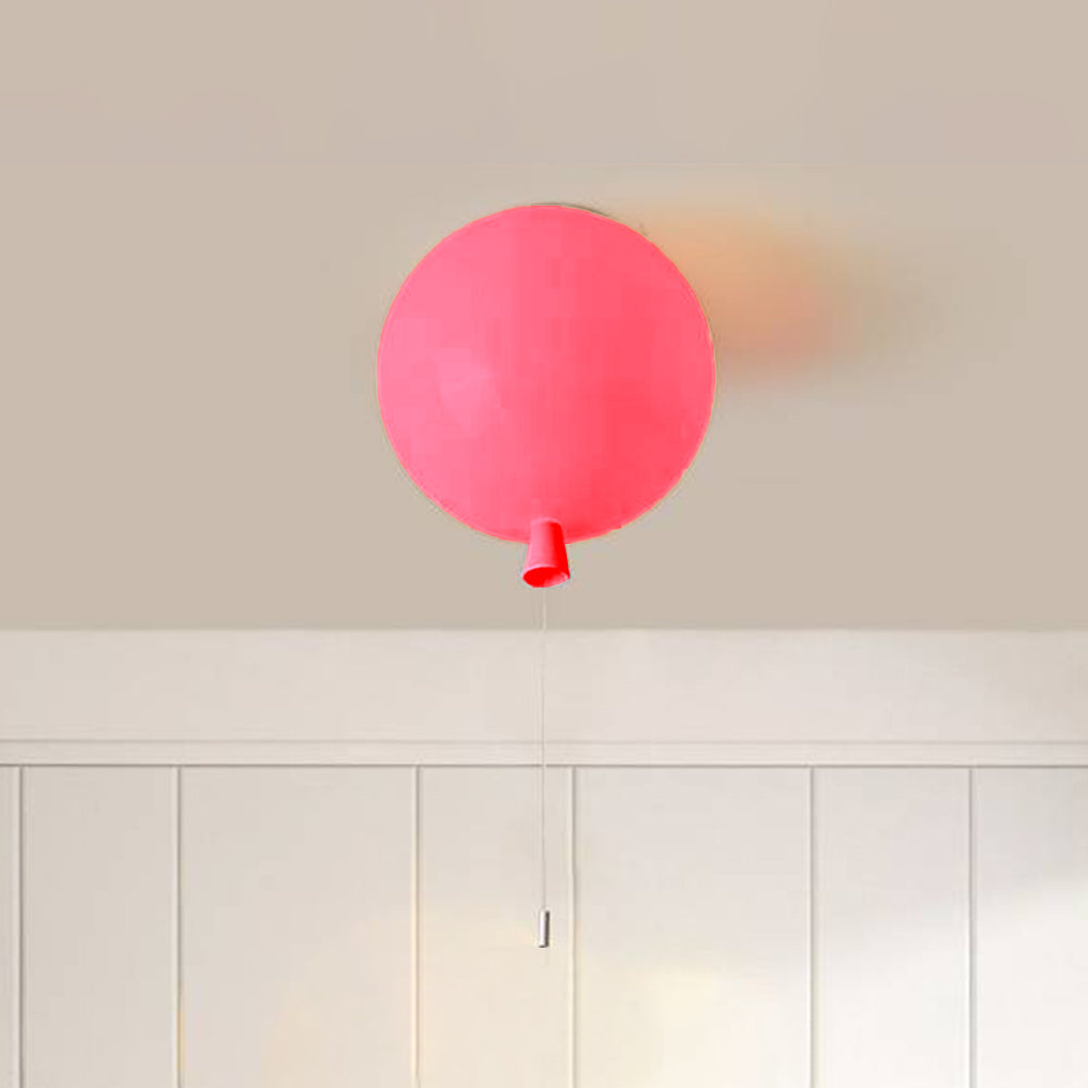 Pink Fateh balloon fitting against a pale ceiling, with a rounded glossy shade, tapered lower neck detail and partly cropped string.