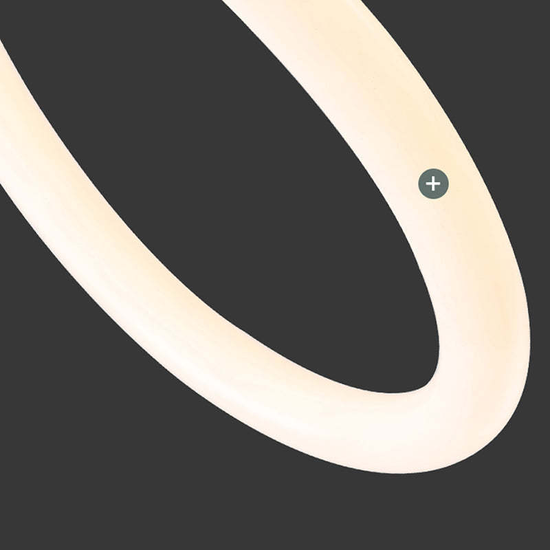 Louise close-up of an illuminated curved white light strip against a dark background.