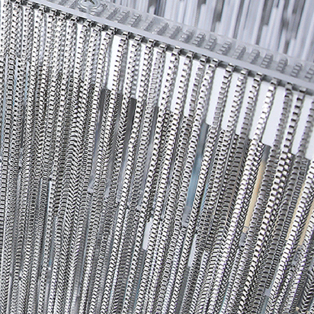 Close view of silver hanging chains beneath a Colon pendant rim