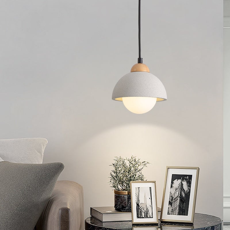 Style A Ozawa dome pendant with a white globe underside beside framed photos.