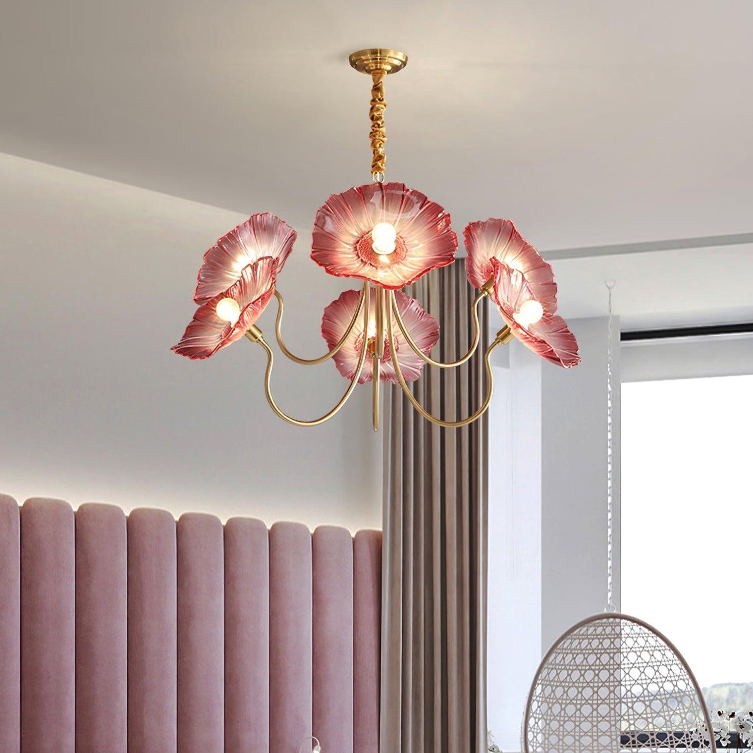 Pink flower chandelier above upholstered headboard