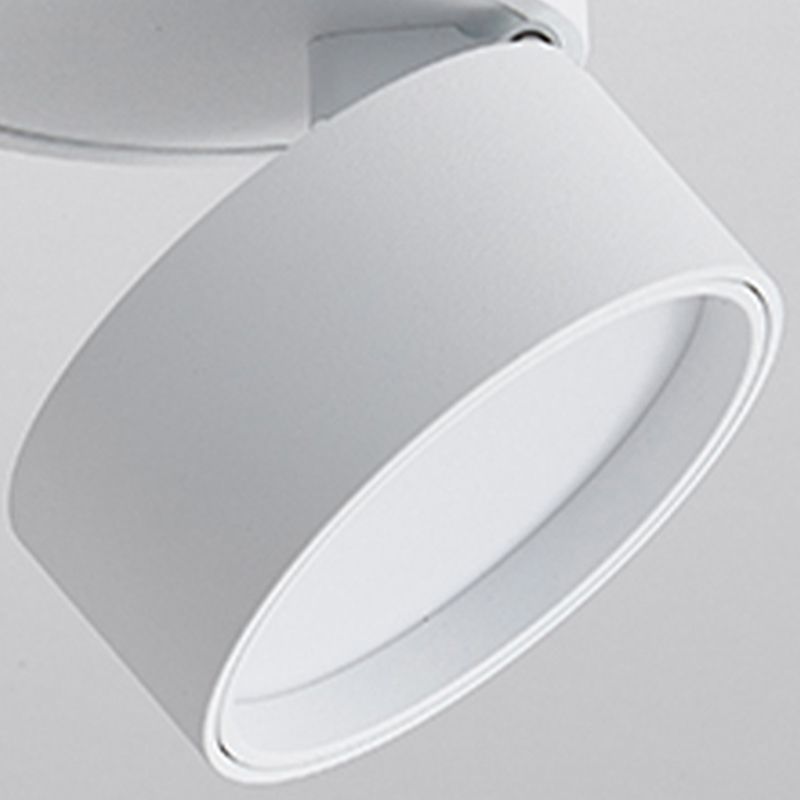 Tilted white Novak head close-up with a circular face, narrow rim and joint beside the ceiling base.