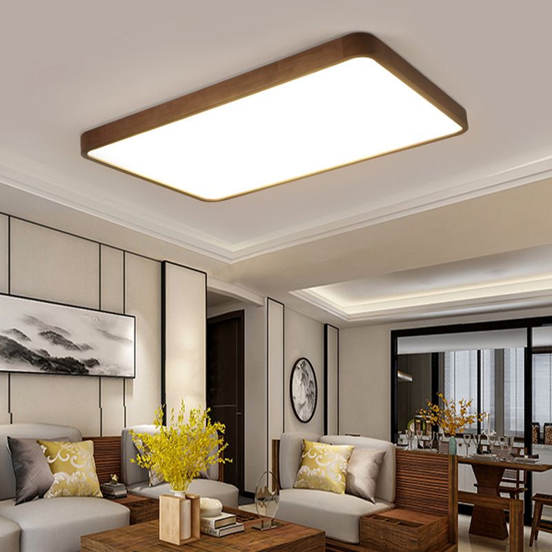 Rectangular Ozawa light in an open living and dining room with wood chairs, mountain artwork, yellow flowers and another chandelier.
