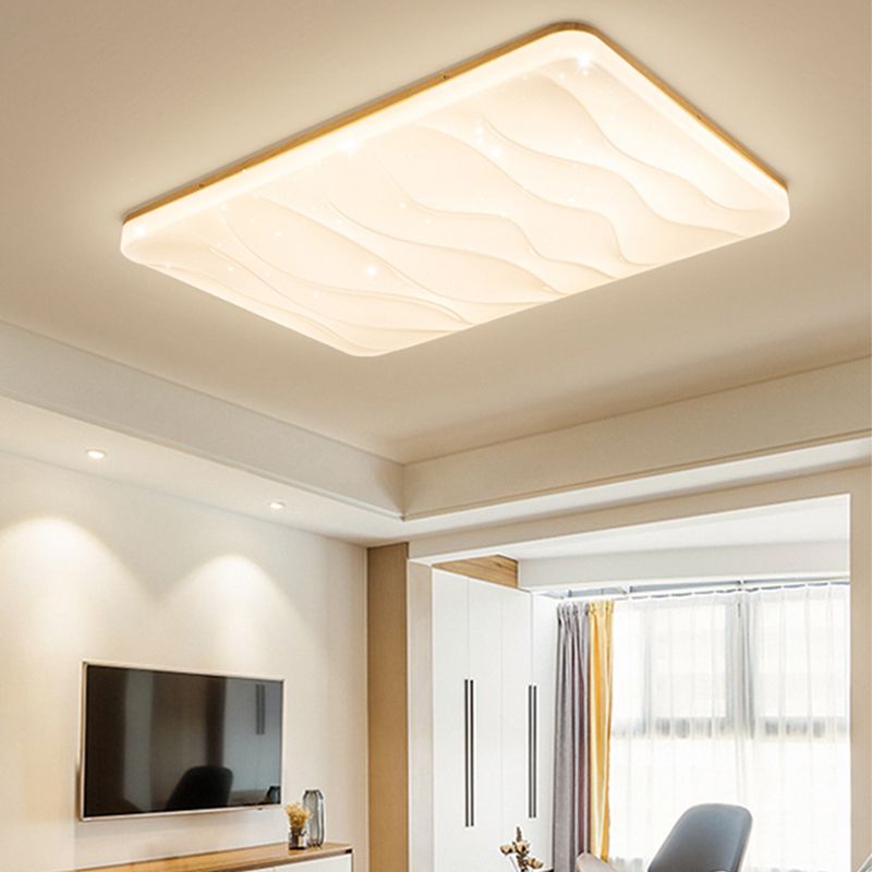 Rectangular Ozawa white rippled ceiling face above a television and low wood cabinet, beside white wardrobe doors, a gray chair and curtains.