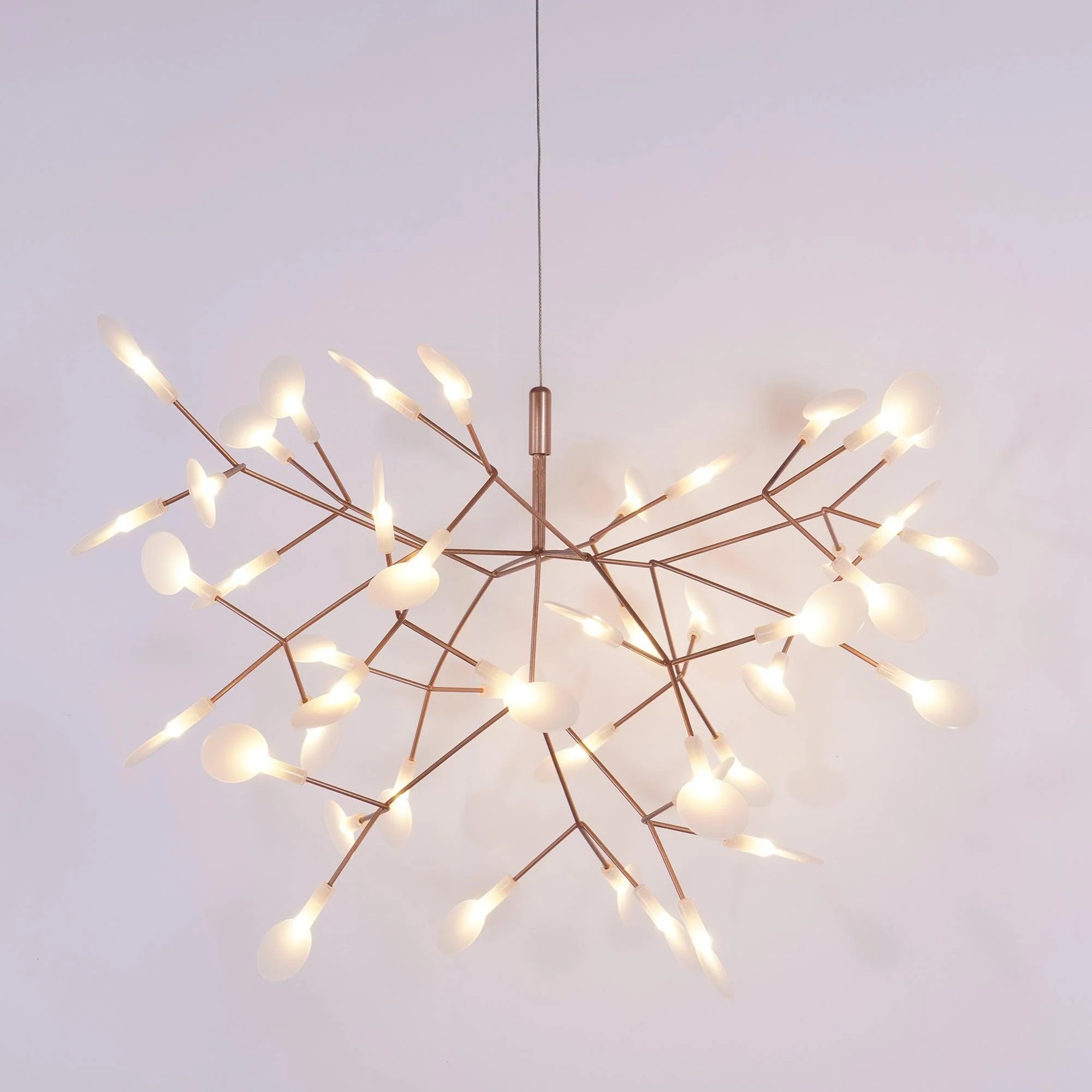 Illuminated rose-colour firefly chandelier against a violet background