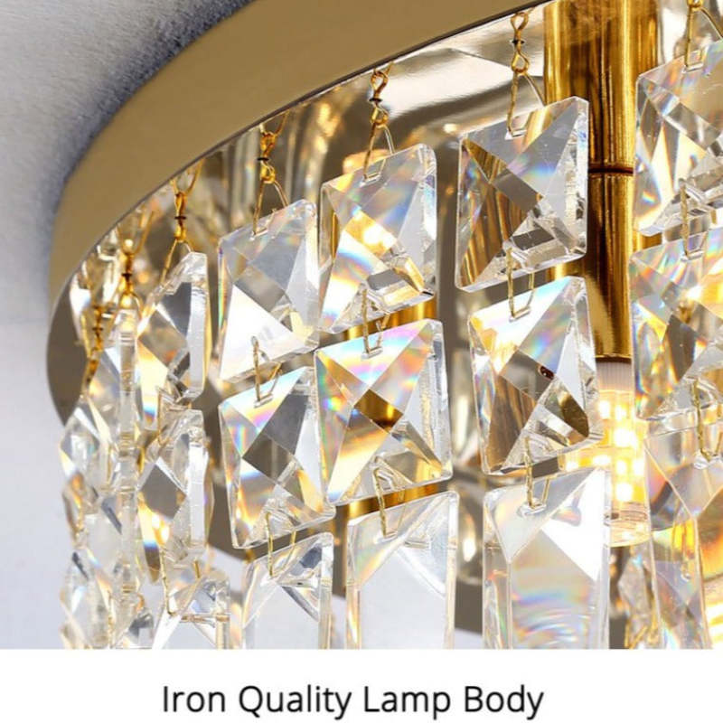 Marilyn rim close-up showing linked clear faceted crystal pieces, small gold-toned hooks and a bright lamp behind the detailing.