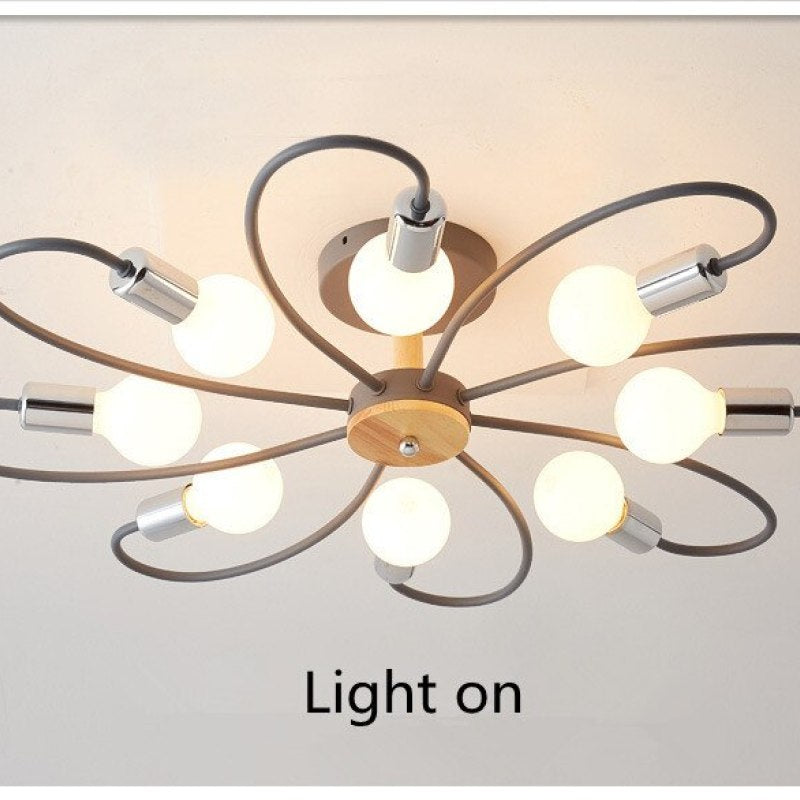 Gray eight-head flower ceiling light switched on, with silver-tone holders and wood-grain central details