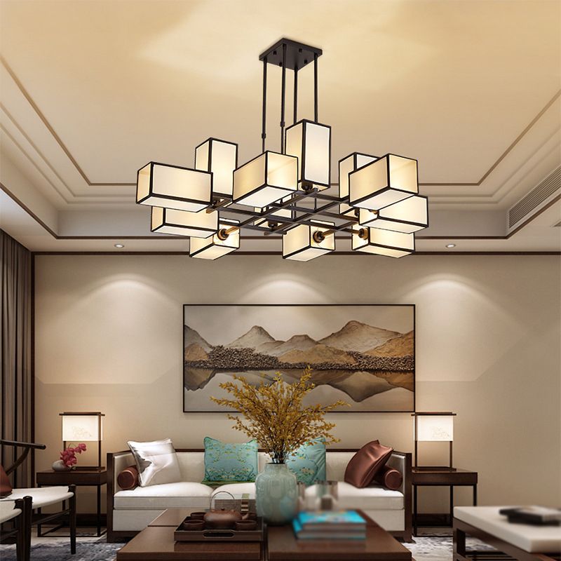 Black geometric fabric chandelier above a living-room seating area