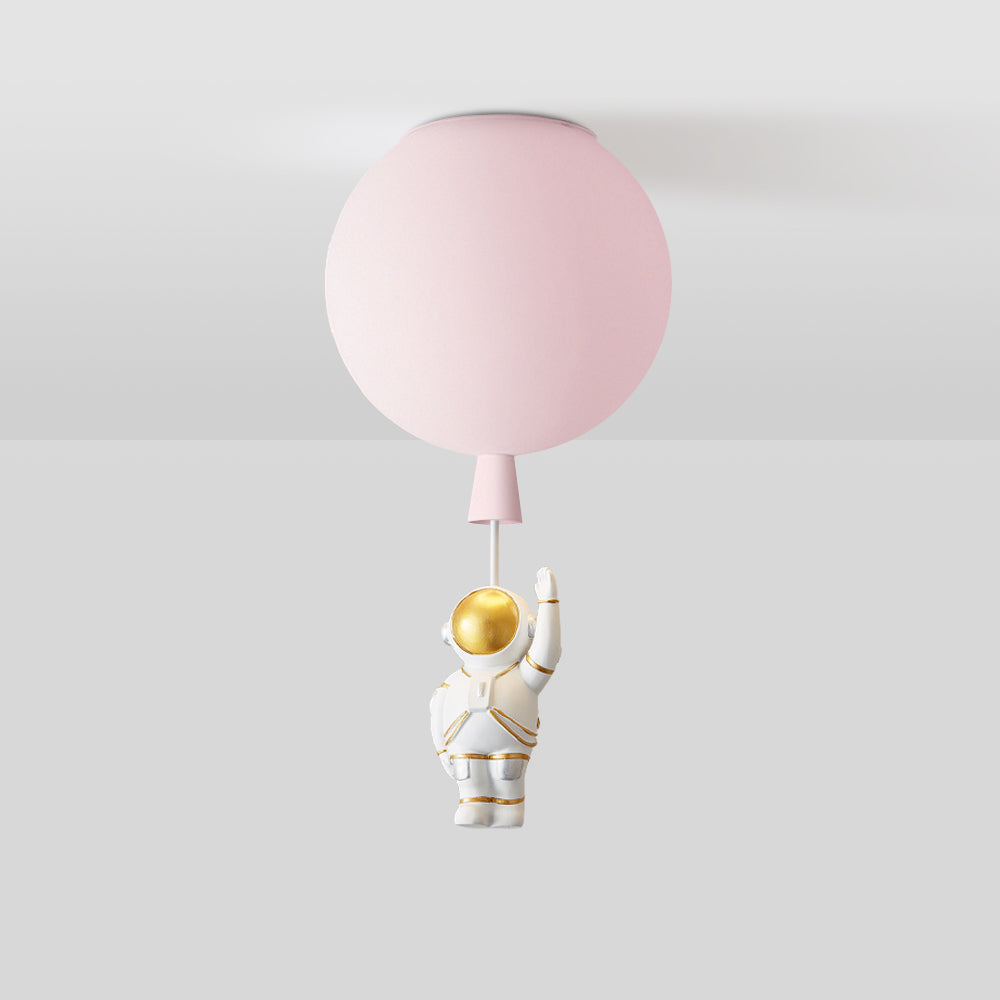 Cropped pink balloon globe at the ceiling with a tapered lower detail and a short pale link; the astronaut is outside the image.