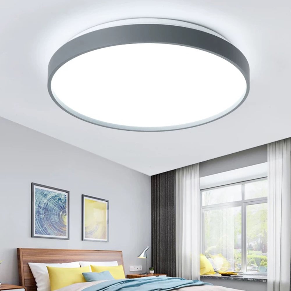 Gray Quinn round ceiling light above a bed near a window