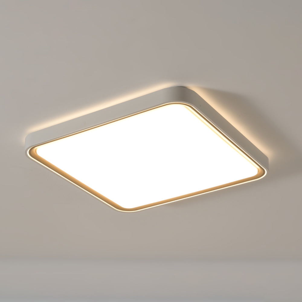 Closer oblique view of square Quinn with a grey frame, gold-tone inner edge, softened corners and a broad glowing pale diffuser.