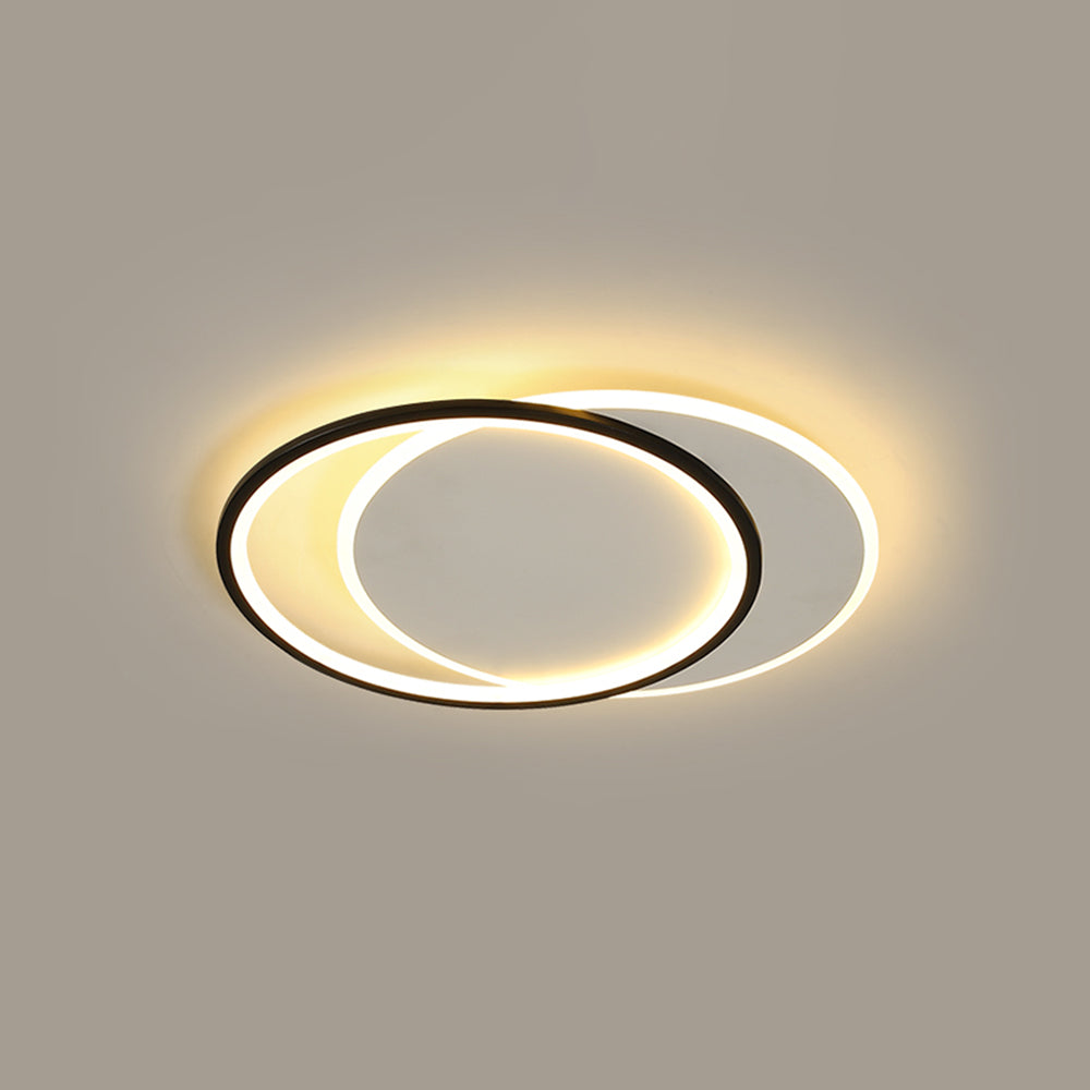 Installed round Quinn light with overlapping black and white circular panels, warm-looking borders and pale inset faces.