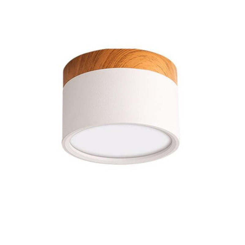 Unlabeled white Morandi cylinder on white backdrop with wood-look upper band and pale round face.
