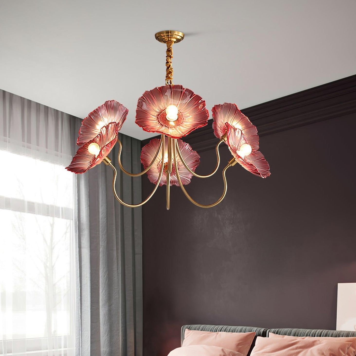 Pink glass flower chandelier above bed