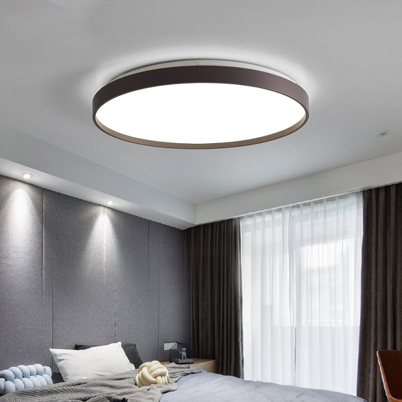 Coffee-colour Quinn round ceiling light above a bed